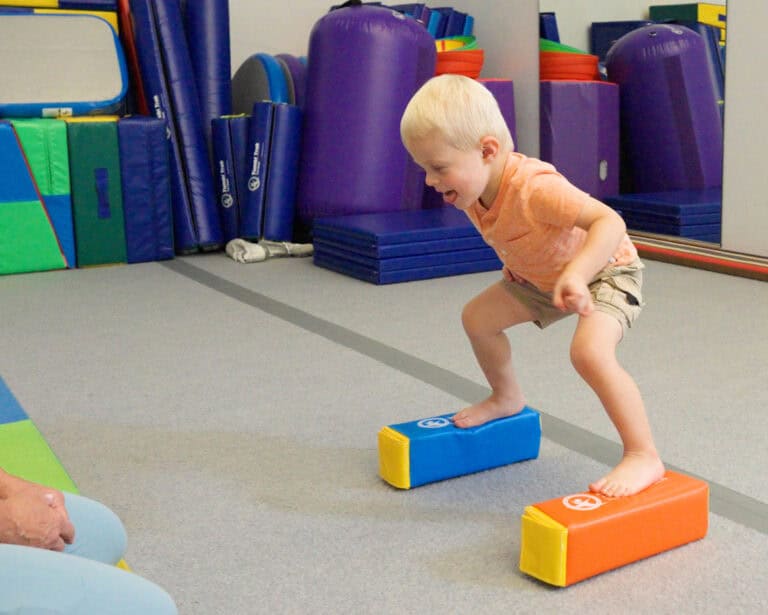A photo of a boy standing on Fun Sticks.