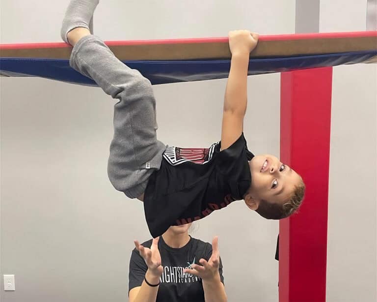 A photo of a client hanging from the Laser Beam Hammock, spotted by his pediatric OT.
