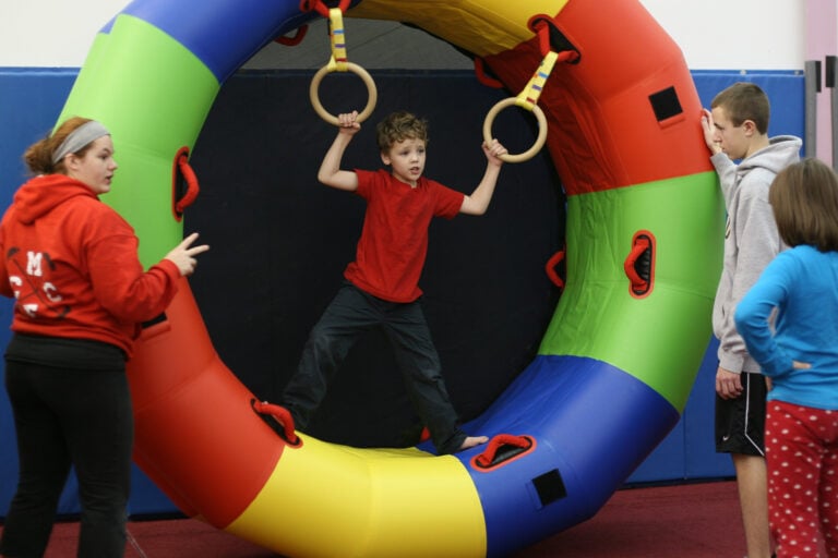 A photo of a child using Movement Rings attached to a Fitness Wheel