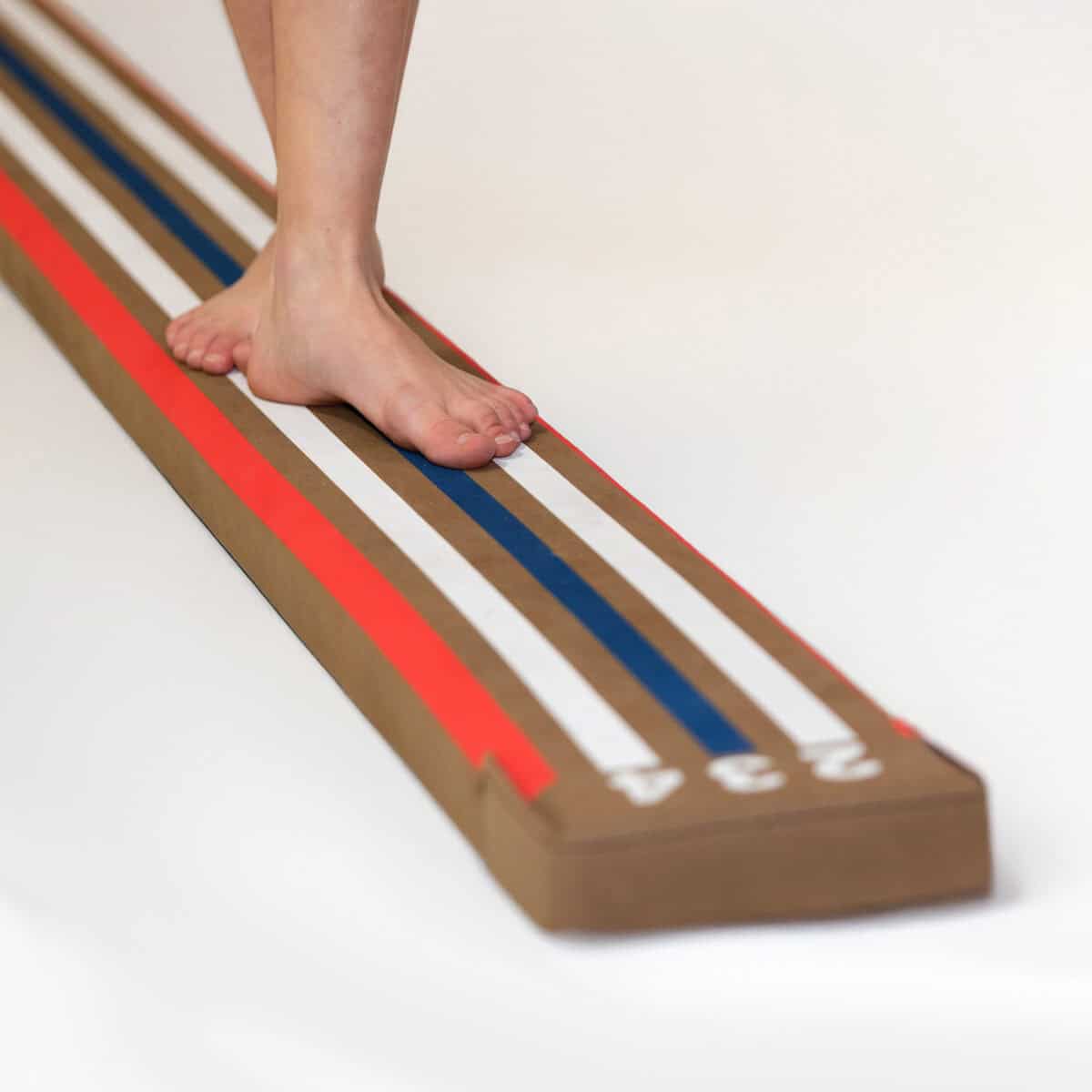 A closeup photo of feet on a Laser Balance Beam